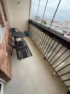 a balcony with a table and a chair on it at Banes me qira in Kosovo Polje