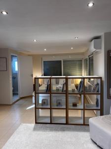 a room with a book shelf with items on it at Apt 1' From The Sea With Private Terrace & BBQ in Vari