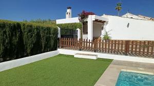 a backyard with a fence and a swimming pool at Cortijo Casablanca in Málaga