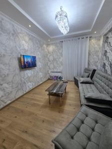 a living room with a couch and a table at Conveniently located near the Tashkent City area, close to the city center in Tashkent