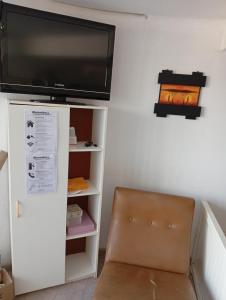 a flat screen tv on top of a white cabinet at Balcón al Tajamar in Alta Gracia