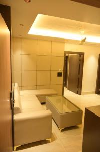 a living room with a couch and a mirror at Diesel inn hotel in Hanumāngarh