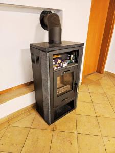 a stove sitting on the floor in a room at Ferienwohnung an der Altmühl - Apartment Hollerstein in Pappenheim +5 photos