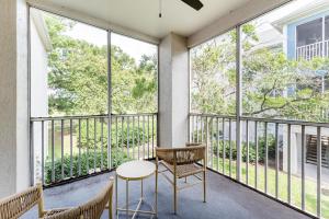a balcony with a table and chairs and windows at Landing Apartments - Southwest Orlando in Orlando