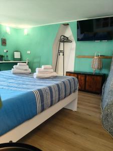 two stacks of towels on a bed in a room at Cech Coast House in the Woods in Civo