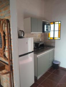 a kitchen with a white refrigerator and a sink at Alojamiento Madariaga 224 in Goya