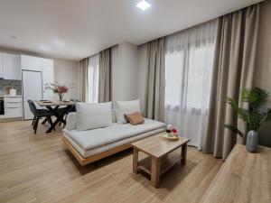 a living room with a couch and a table at Cyclopean View Suites in Nafplio