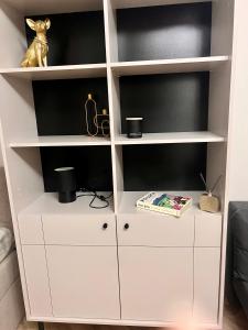 a white book shelf in a living room at Old Town Square Szczecin in Szczecin
