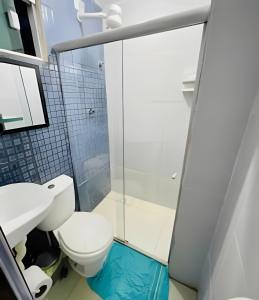 a bathroom with a toilet and a glass shower at Flat em Maracaípe -Praia vizinha Porto de Galinhas in Porto De Galinhas +25 photos