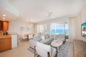 a living room with a couch and a table at Beachcomber 27 in George Town