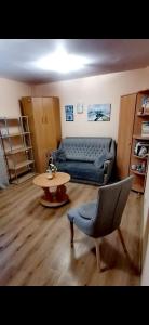 a living room with a couch and a table at MINiLUx in Ventspils