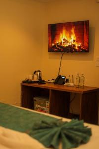 a fireplace in the corner of a room with a desk at De Rain Eco Beach Resort in Entebbe +23 photos