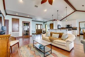 a living room with a couch and a table at Private Beach and Views! Stilted Ocean Springs Home in Gulf Park Estates