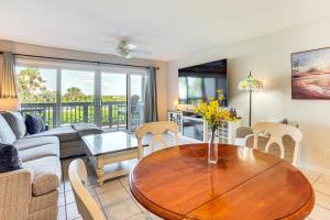 a living room with a table and a couch at Poolside Fun & Ocean Strolls: Harbor Island Haven! in Fripp Island