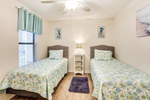 a bedroom with two beds and a window at Poolside Fun & Ocean Strolls: Harbor Island Haven! in Fripp Island +17 photos
