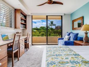 a bedroom with a bed and a desk at Polo Beach Club 301 in Wailea