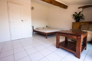 a living room with a bed and a table at La bergerie du chateau de Fitou in Fitou