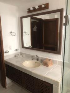 a bathroom with a sink and a mirror at studio Opa in Puerto Vallarta