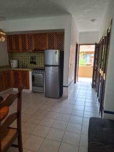 a kitchen with a stainless steel refrigerator and a tile floor at studio Opa in Puerto Vallarta