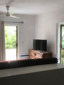 a living room with a couch and a flat screen tv at studio Opa in Puerto Vallarta