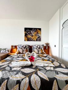 a bedroom with a bed with towels on it at Ti-CHERRY in Le Diamant