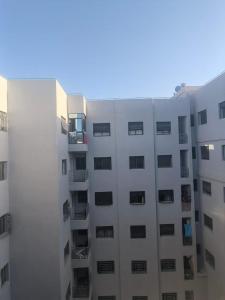 a white apartment building with windows on the side at Mydar Airport in Tangier +19 photos
