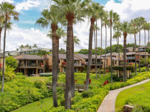 a row of palm trees in front of a resort at Wailea Elua Village 1102 in Wailea