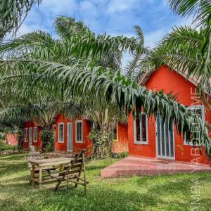 a red house with a picnic table in front of it at ambayard 