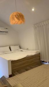 a bed in a room with a large at Deem view in Al Ain