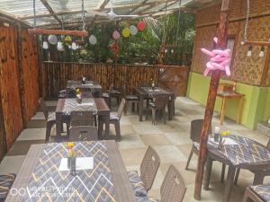 a restaurant with tables and chairs and a pink bunny on a pole at Jungle in San Francisco