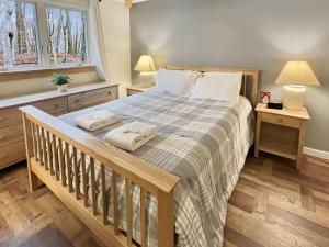 a bedroom with a large bed with two towels on it at Woods Village 43 in Killington +29 photos