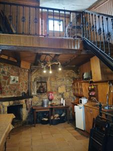 a kitchen with a staircase and a table in a room at Bodega típica en El Molar sin camas ni dormitorios in El Molar