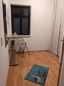 a living room with a wooden floor and a window at K&K City-Apartment in Weimar