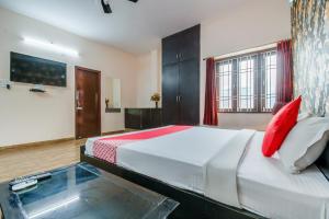 a bedroom with a large bed with red pillows at Hotel O Awirank in Patna