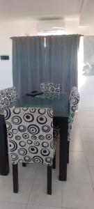 a table and two chairs in a room at Departamento luminoso amplio in San Antonio de Areco +1 photo