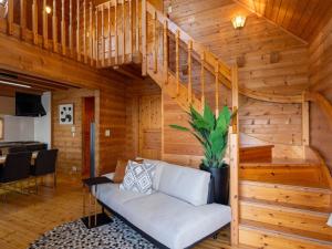 a living room with a staircase and a couch at Villa & Sauna - NAGIOTO - - Vacation STAY 20253 in Fujinowaki