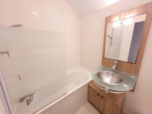 a bathroom with a sink and a mirror and a tub at Havre de paix à Azay-le-Rideau - piscine chauffée in Azay-le-Rideau +23 photos
