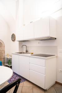 une cuisine avec des armoires blanches et un évier dans l'établissement Casa La Turchese, à Gualdo Tadino 20 autres photos