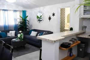 a living room with a blue couch and a table at Apartamento entero en Samaná Los tios 1 y 2 in Santa Bárbara de Samaná