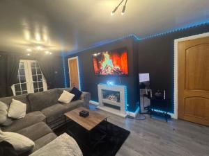 a living room with a couch and a fireplace at A Star Living in Liversedge