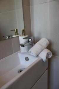 a bathroom sink with a towel sitting on it at Proline Serviced Apartments 