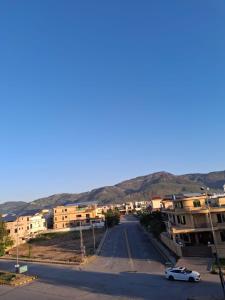 an empty street in a small town with buildings at The Capital Inn in Islamabad