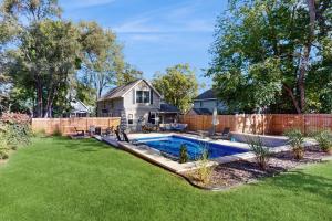 a backyard with a swimming pool and a fence at Merchant Street Retreat in New Buffalo
