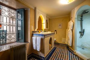 a bathroom with a tub and a sink and a shower at Dar Alhambra Riad Medina in Marrakech +89 photos