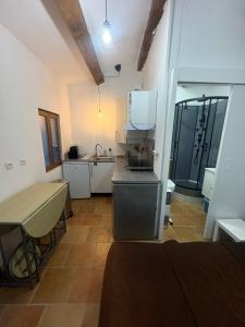 a small kitchen with a counter and a sink at Le Cabanon des Collines in Signes