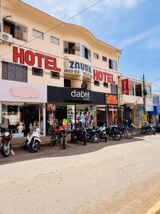 a row of motorcycles parked outside of a hotel at Hotel Izaura Centro Comercial Juruaia in Juruaia