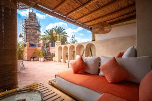 a living room with a couch on a patio at Dar Alhambra Riad Medina in Marrakech
