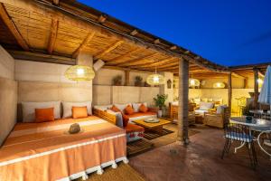 a bedroom with a bed and a living room at Dar Alhambra Riad Medina in Marrakech