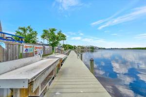 a dock at the end of a body of water at Palm Terrace Waterfront Htd Pool Hot Tub Tennis in Gulf City