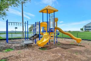 a playground with a slide in a park at Palm Terrace Waterfront Htd Pool Hot Tub Tennis in Gulf City +14 photos